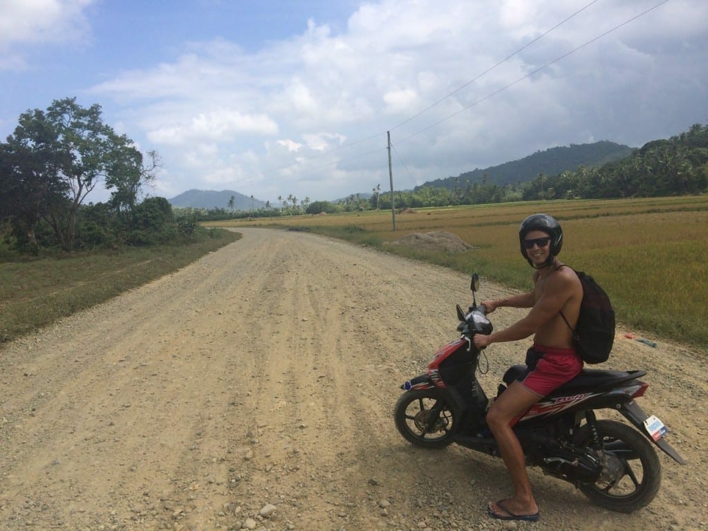 Pericles Rosa driving a motorbike to Nacpan Beach, El Nido, The Phippines
