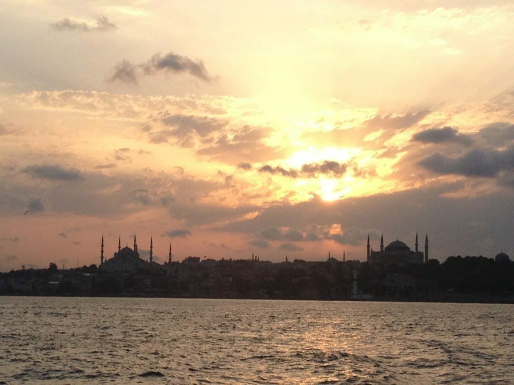 View of the sun setting in Istanbul from a boat on the Bosphorus channel 