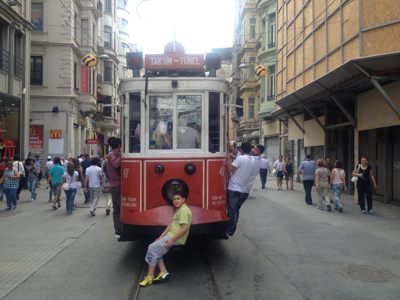 People riding an old tram in Istanbul.