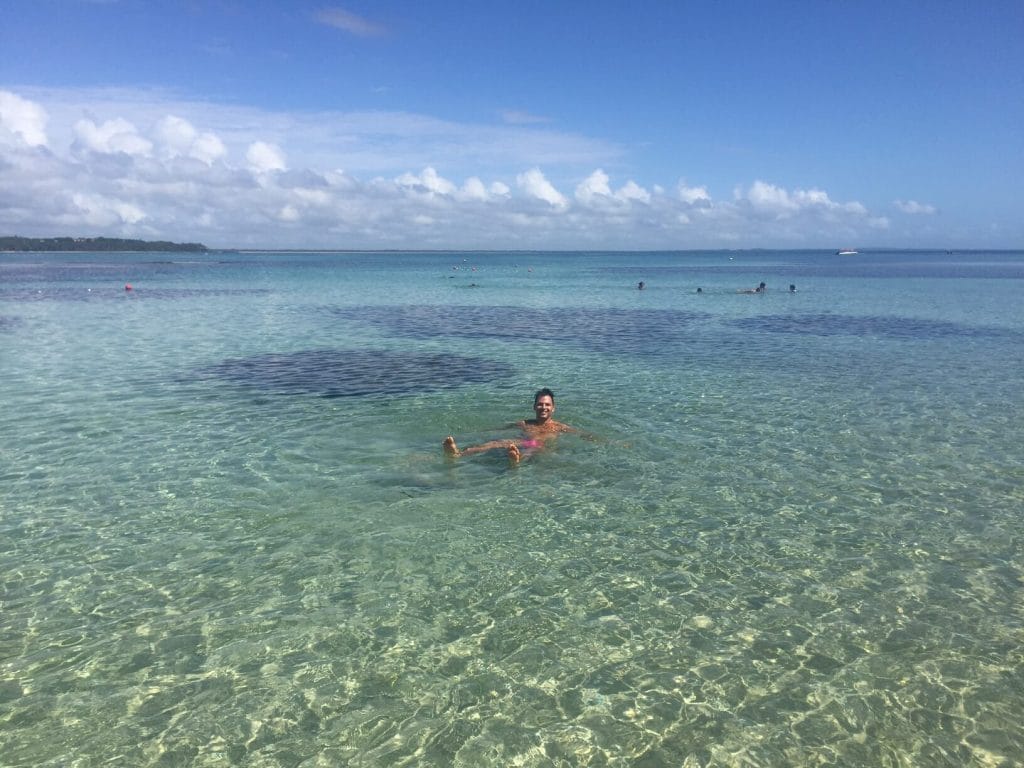 A man in the natural pools of Moreré Beach, Boipeba Island, Brazil