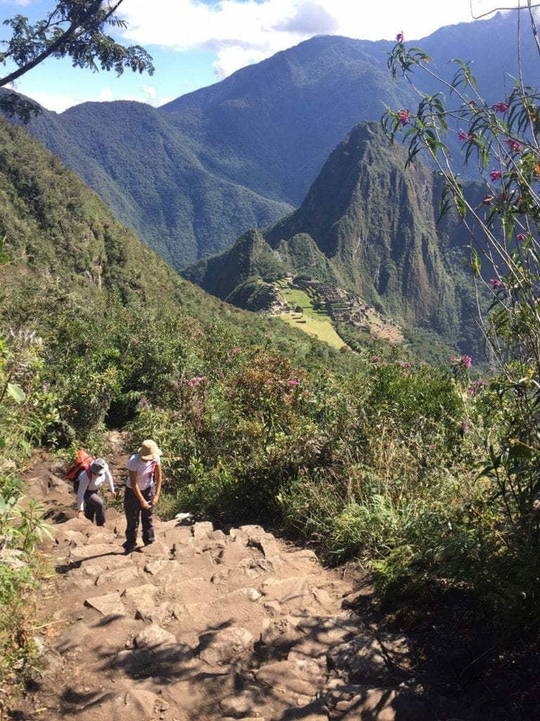 two people hiking up Montaña Machu Picchu