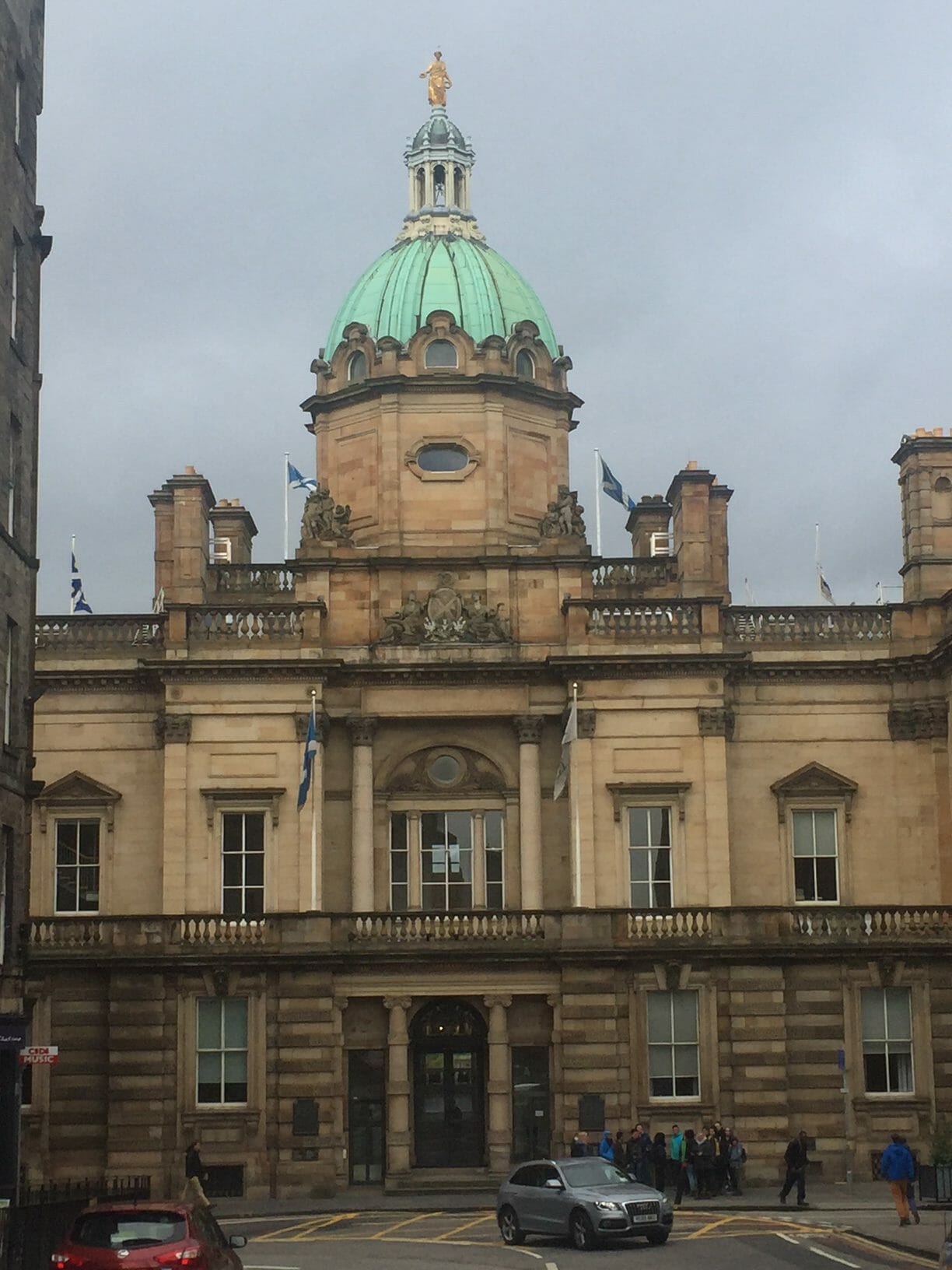 the beige façade of the Museum on the Mound withe a green dome and a gold statue on the top