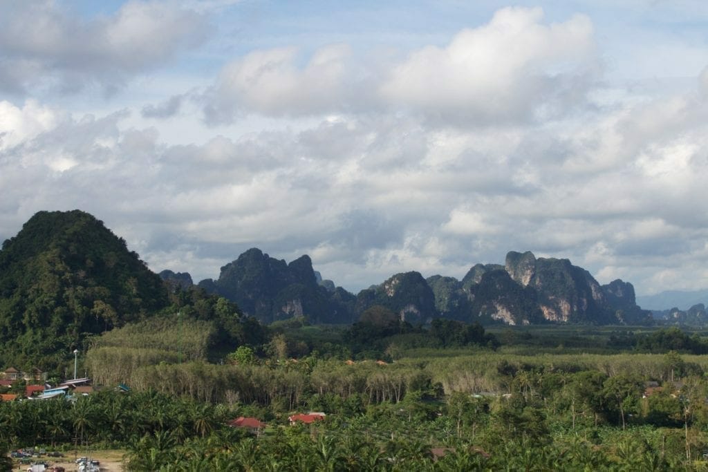 The colossal limestone mountains covered by vegetation that surround the city of Ao Nang in the province of Krabi, Thailand