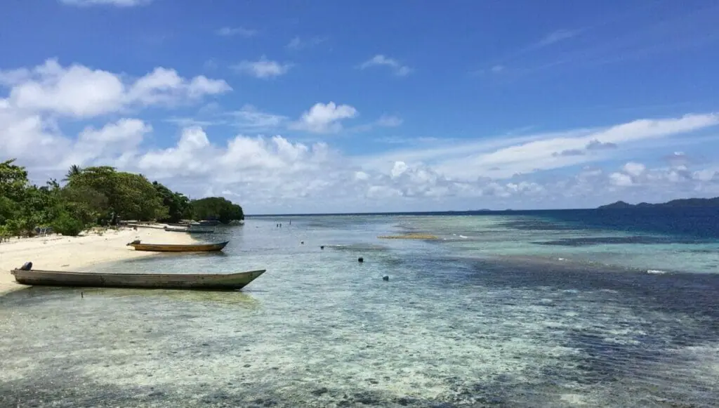 Some canoes docked on a deserted beach in Raja Ampat, Indonesia