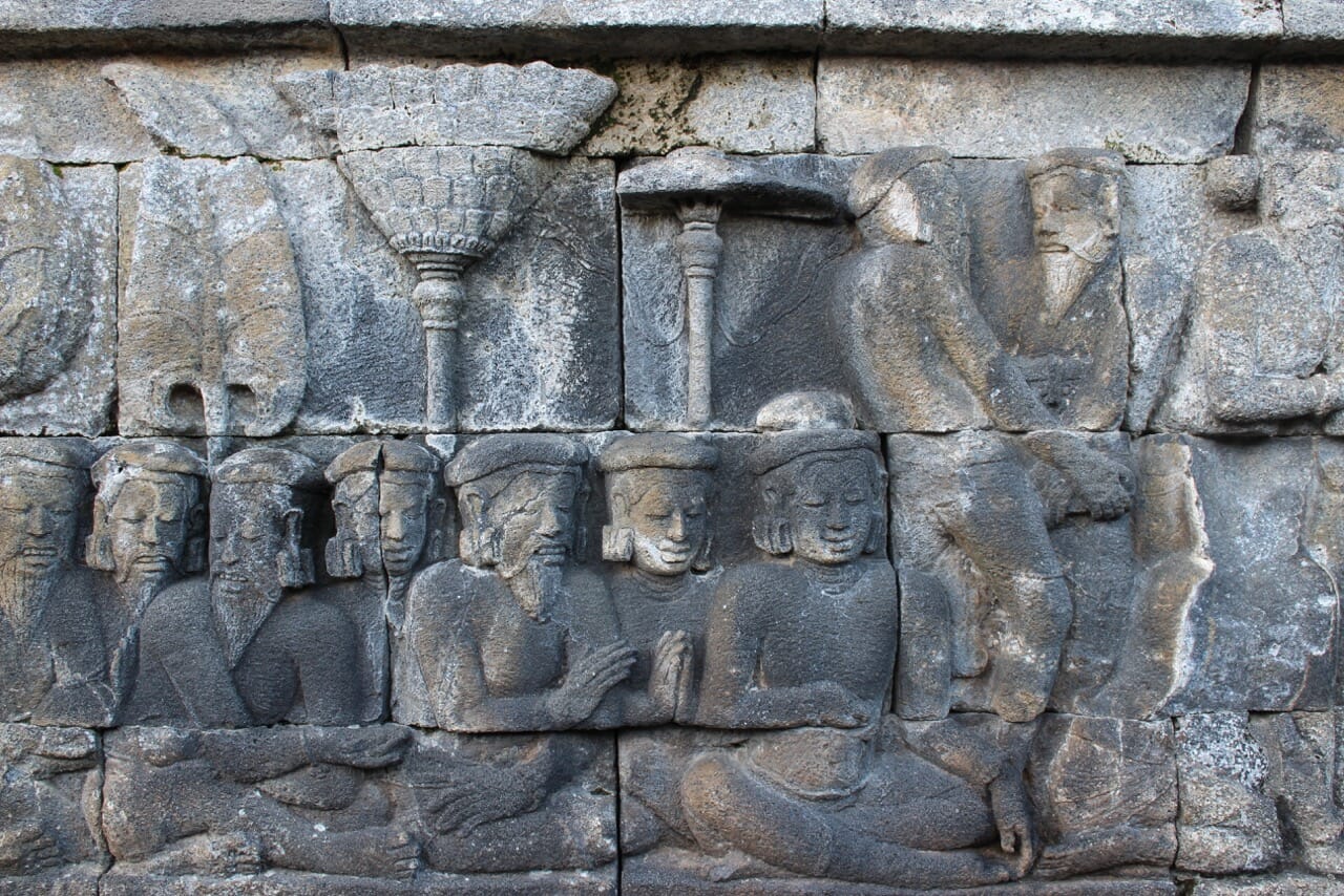 A carved relief panel with illustrations of Buddhist beliefs