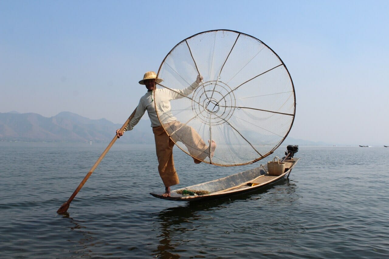 A fisherman using a conical basket known as “ngaphankon” for fishing at Inle Lake, Myanmar
