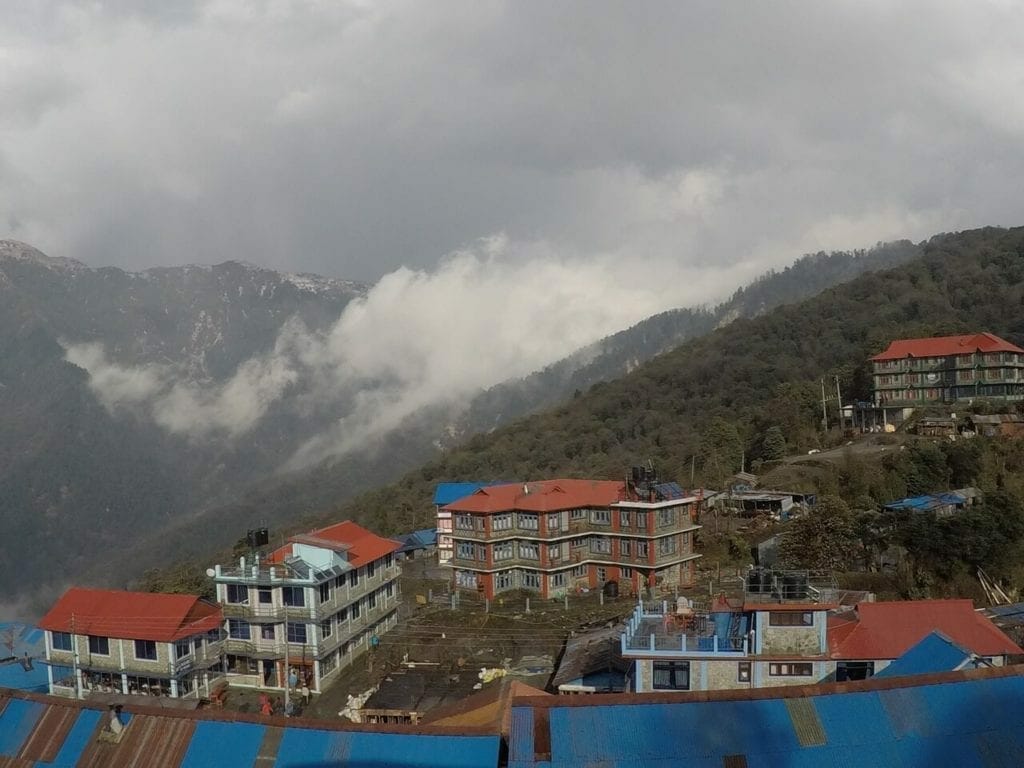 Some 4-storey buildings surrounded by mountains in the village of Ghorepani in Nepal