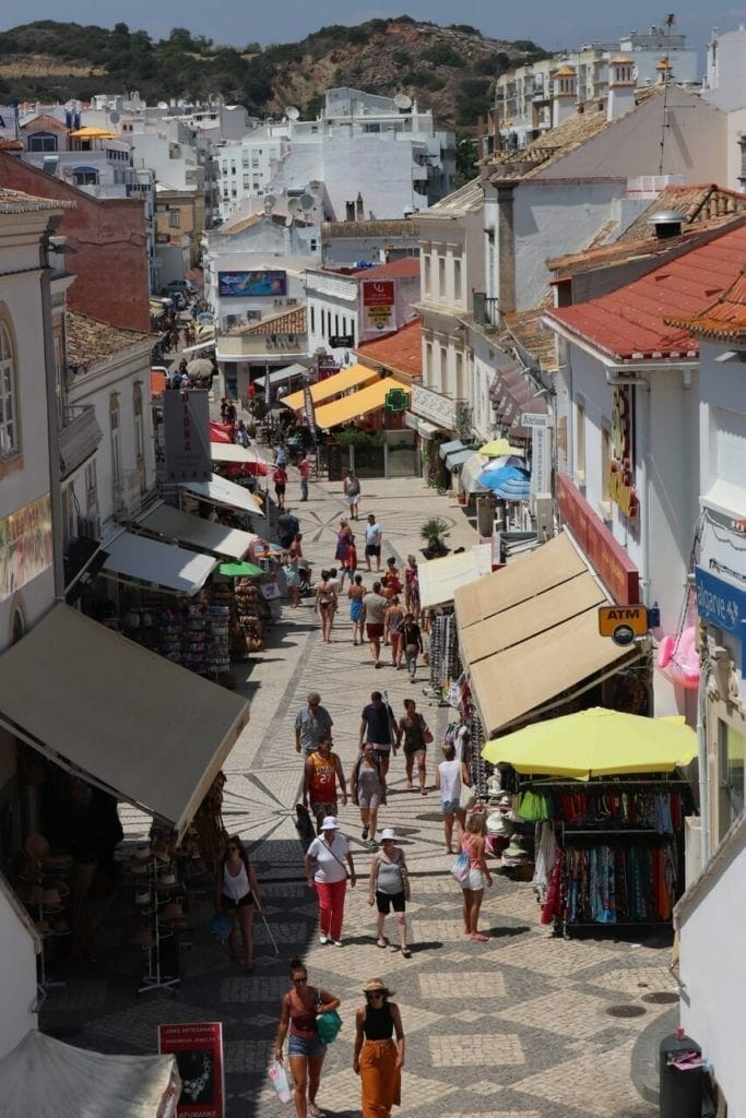 Some people walking on a shopping street in Albufeira old town