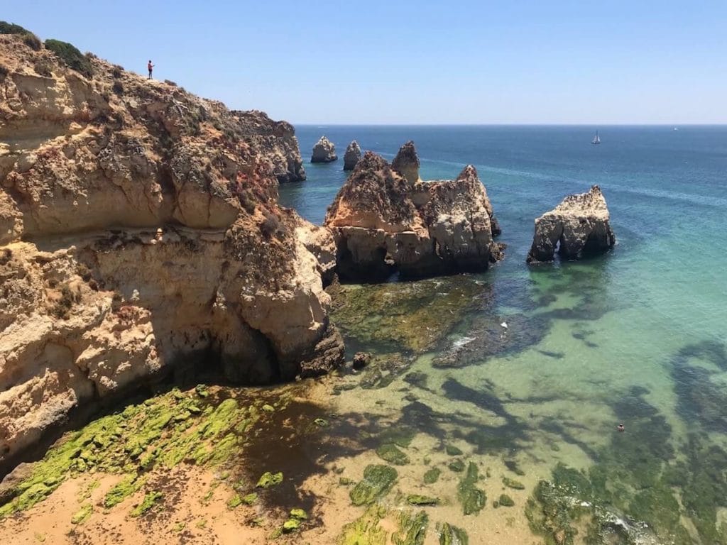 The massive ochre limestones cliffs and crystalline blue water of Prainha, one of the best Algarve beaches