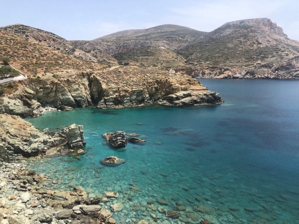 A beach surrounded by mountains in Folegandros, Greece