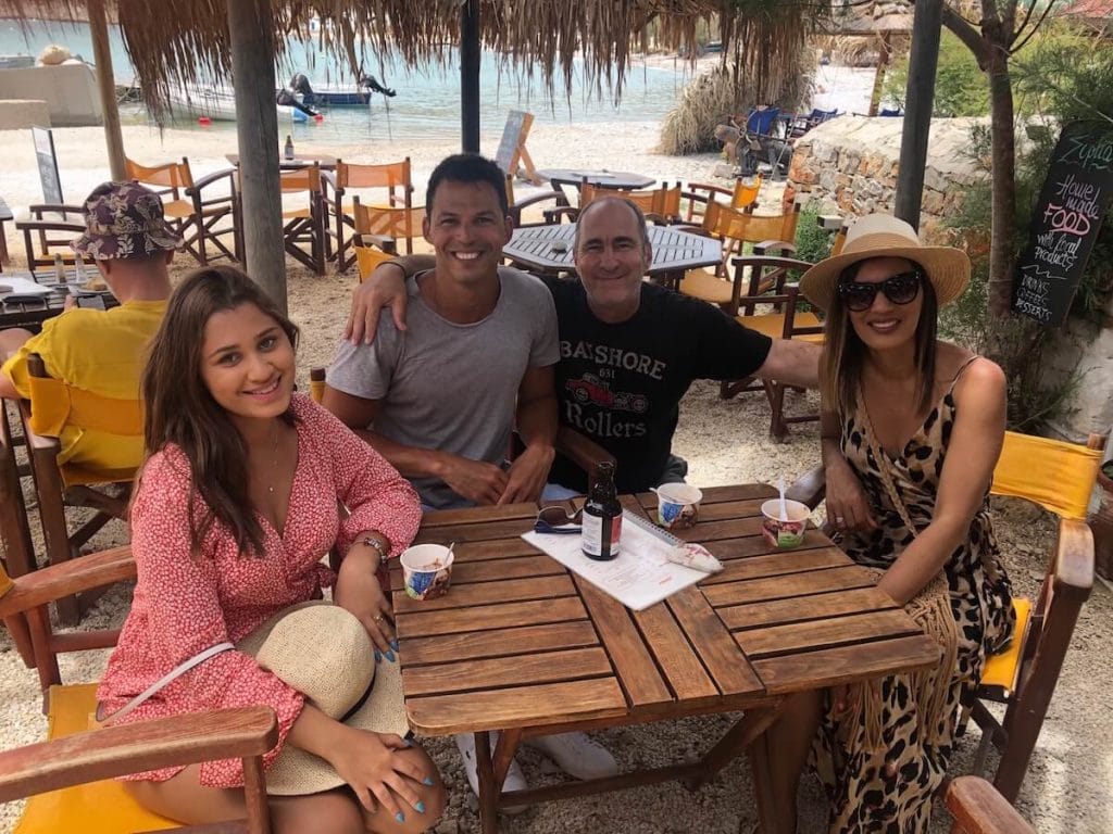 Four people sitting in a restaurant in Folegandros, Greece