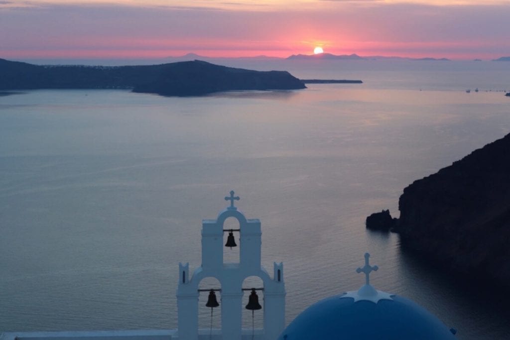 Saint Theodoros Thira Holy Orthodox Church and the sun setting in the background