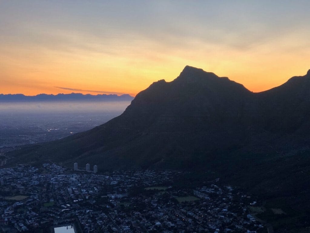 The sun rising behind the mountains around Cape Town