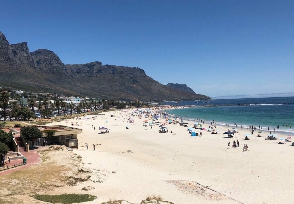 Camps Bay Beach and its white soft sand, blue water and the Twelve Apostles Mountain in the background, Cape Town, South Africa