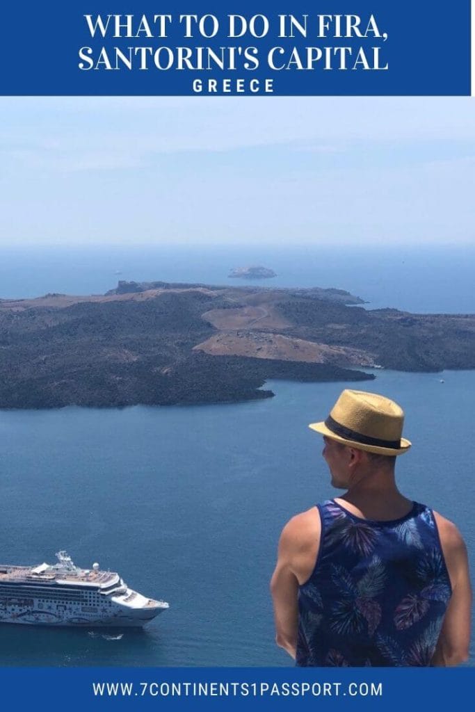 a man wearing a brown hat and blue tank top admiring the view of a cruise ship sailing in the Aegean Sean and Nea Kammeni Island in Fira, Santorini