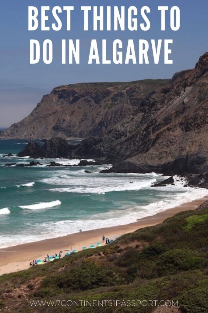 a beach on the Vicentine Coast, Algarve, with enormous black cliffs and crystal-clear water