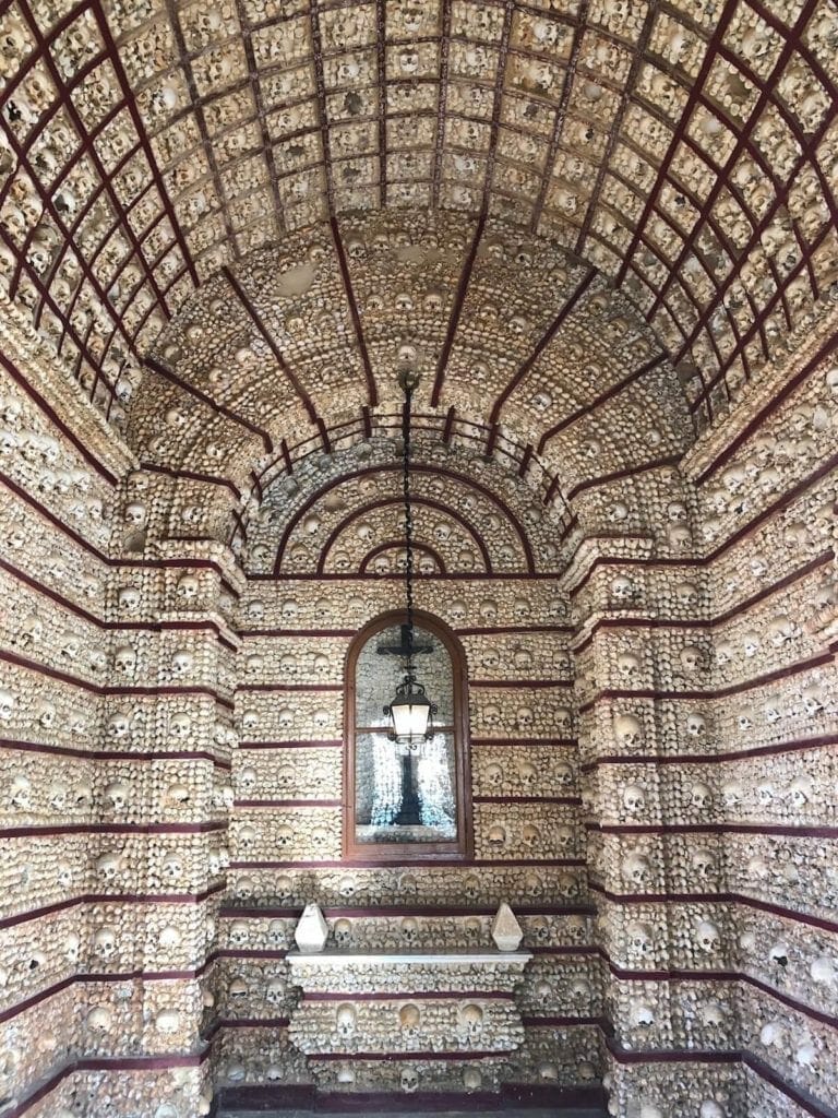 The interior of Faro bone chapel with walls and ceiling covered with bones and skulls
