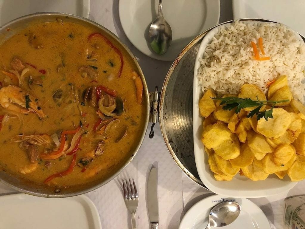 Cataplana de mariscos, a dish made with seafood with herbs, tomatoes and white wine, served with rice and potatoes in a restaurant in Lagos, Portugal