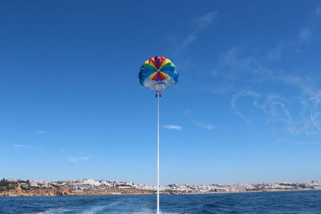 Un colorido parasail frente a la costa de Albufeira, Algarve, Portugal