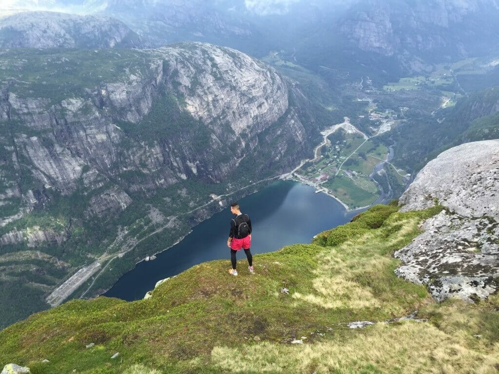 Pericles Rosa on the edge of Kjerag Mountain, Norway, admiring the breathtaking view of Lysefjord