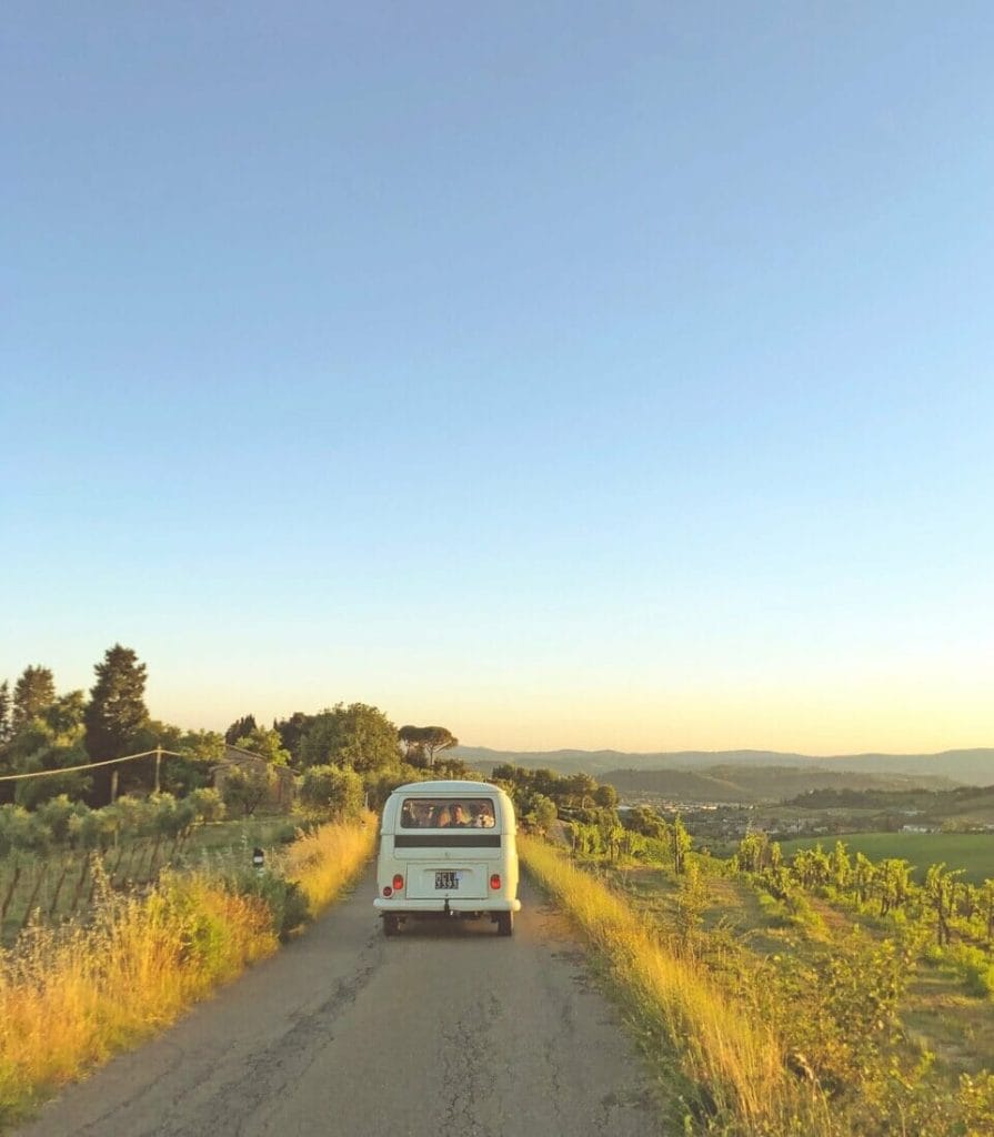 People driving a vintage kombi on a road in the UK