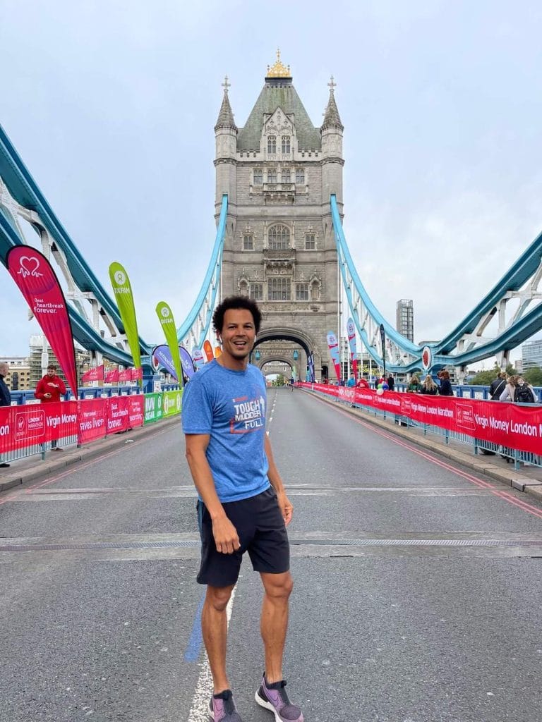 Pericles Rosa wearing a blue t-shirt and black shorts running at Tower Bridge, London