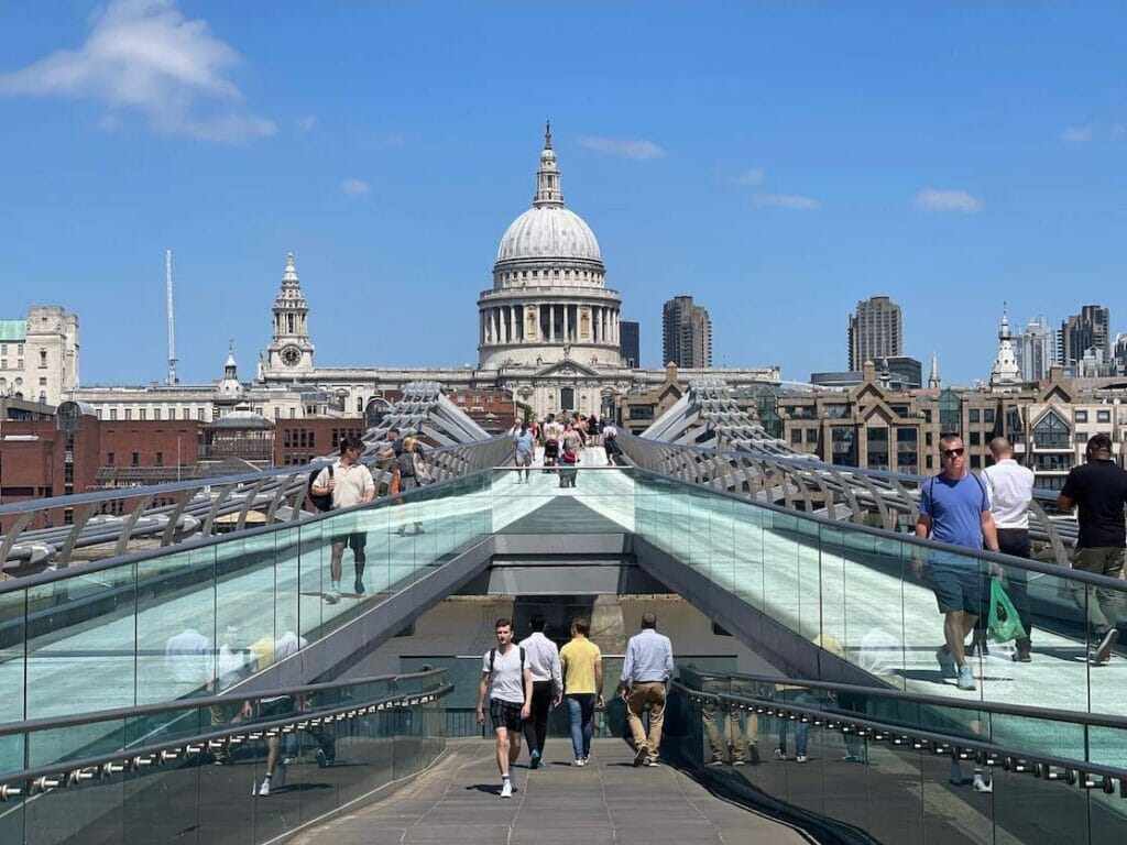 People walking on Millennium Bridge with Saint Paul's Cathedral as a backdrop