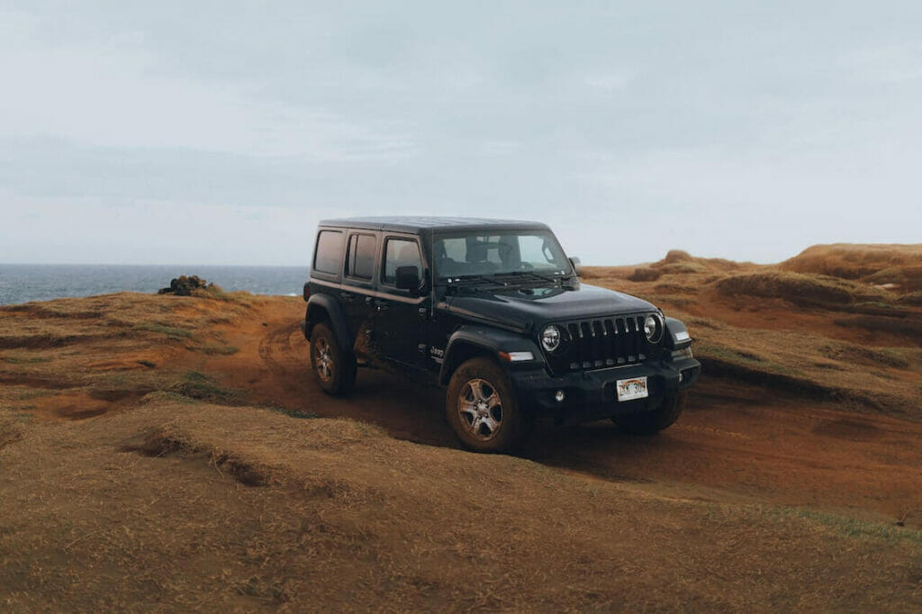 A Jeep Wrangler on a dirty road