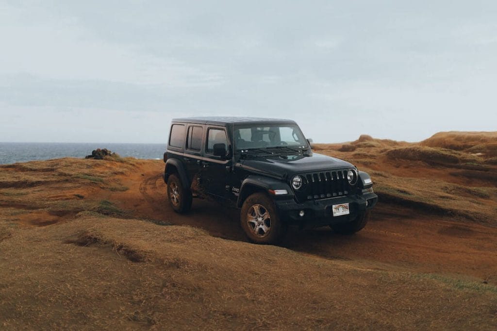 A Jeep Wrangler on a dirty road