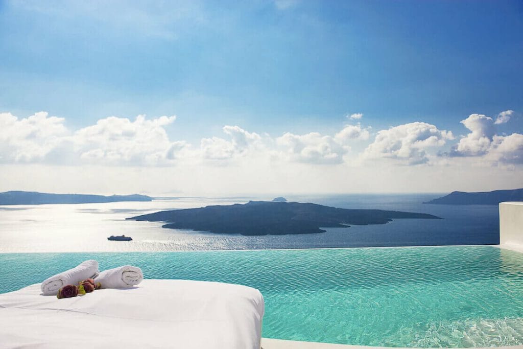 A infinity swimming pool overlooking the volcano and the Aegean Sea, at Cosmopolitan Suites, Fira, Santorini