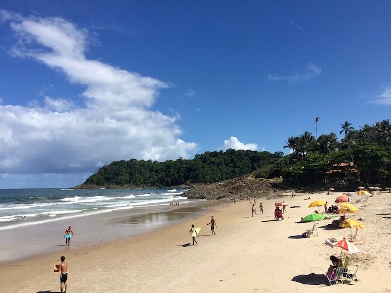 Beachgoers and surfers at Praia da Tiririca, Itacare, Bahia, Brazil
