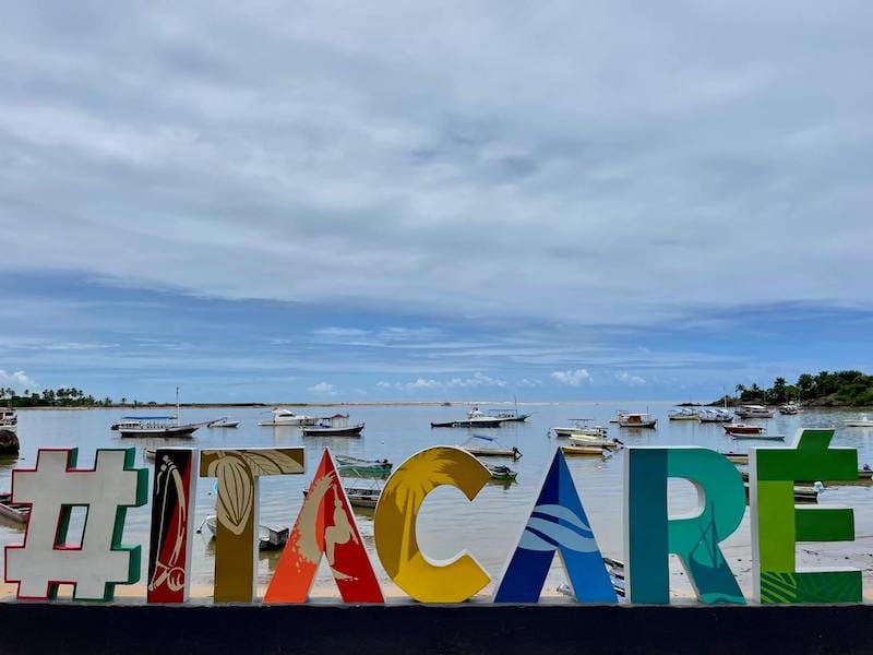 A big sign written Itacare at Praia da Concha with the beach in the background, Itacaré, Bahia, Brazil