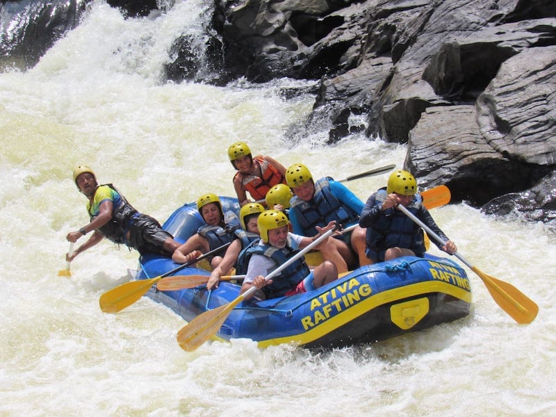 People on a boat doing a white-water rafting on Rio de Contas, Taboquinhas, Bahia, Brazil