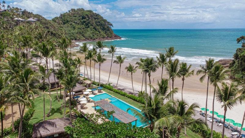 Aerial view over Sao Jose Beach Club & Hotel swimming pool and Sao Jose Beach, Itacare, Bahia, Brazil