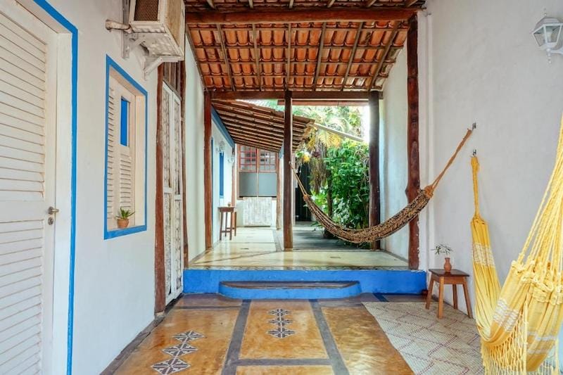 A corridor with two hammocks of Tropicalia Hostel and Pousada, Itacare, Bahia, Brazil