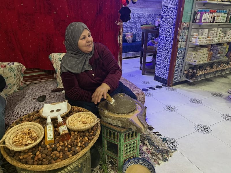 A woman producing argan oil in a berber pharmacy in Marrakech, Morocco