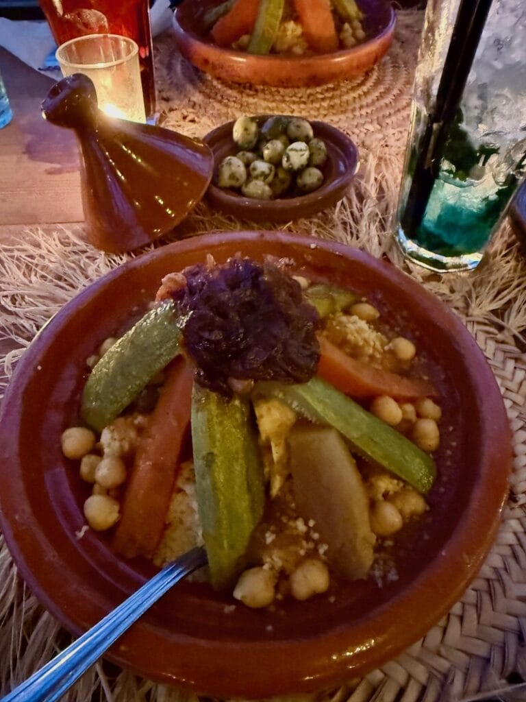 Chicken couscous served on a clay pot at Alkamar Camp, Agafay, Morocco